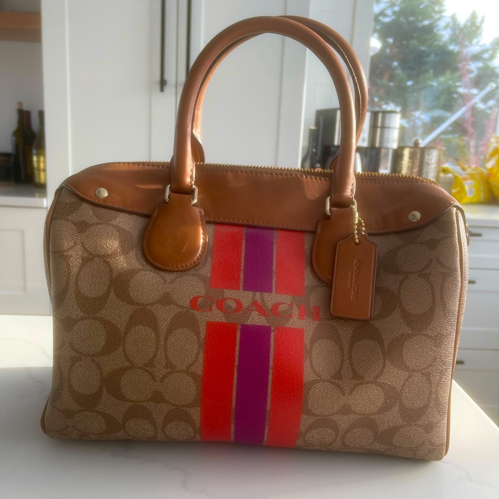 Coach mid size handbag. Classic coach design with a spring color accent.
